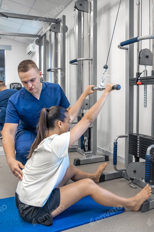 Preview: Physical Therapist Helping Patient Exercise on Weight Machine