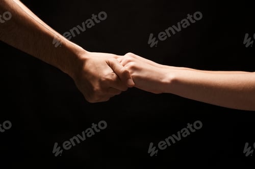 Preview: Male And Female Hands Holding Tight Together On Black Isolated Background. Love, Relations