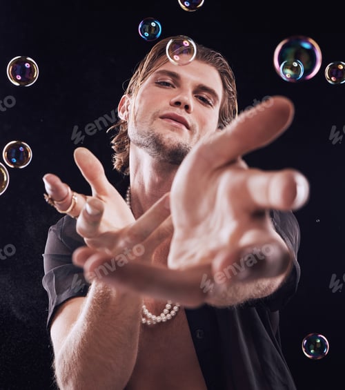 Preview: Bubbles, hands and man in studio for magic portrait, art performance and creative by black backgrou