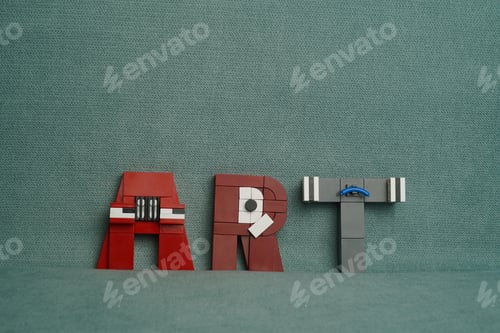 Preview: Miniature figure of the word Art against a green fabric background