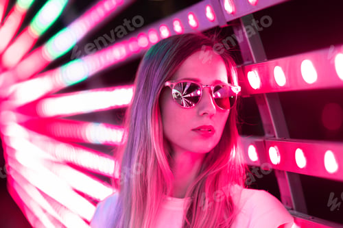 Preview: Young woman standing on Background Color of the year 2023 viva magenta. Trendy colors concept