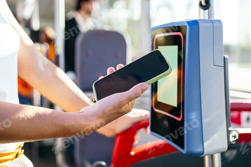 Preview: Woman paying for public transport with mobile phone