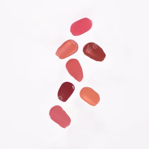 Preview: Close-up of a collection of colorful lipstick samples on a white background