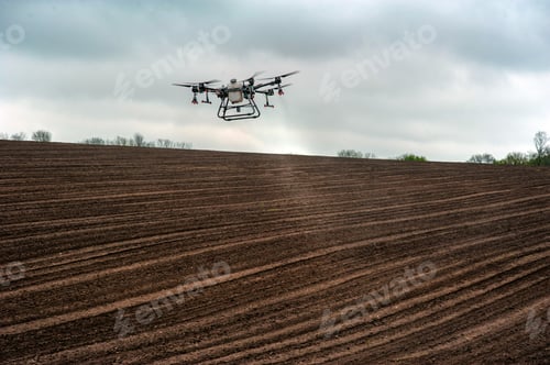 Preview: Drone Flying Above Tilled Field on Overcast Day