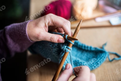 Preview: Close Up on Knitting Needles with Blue Yarn