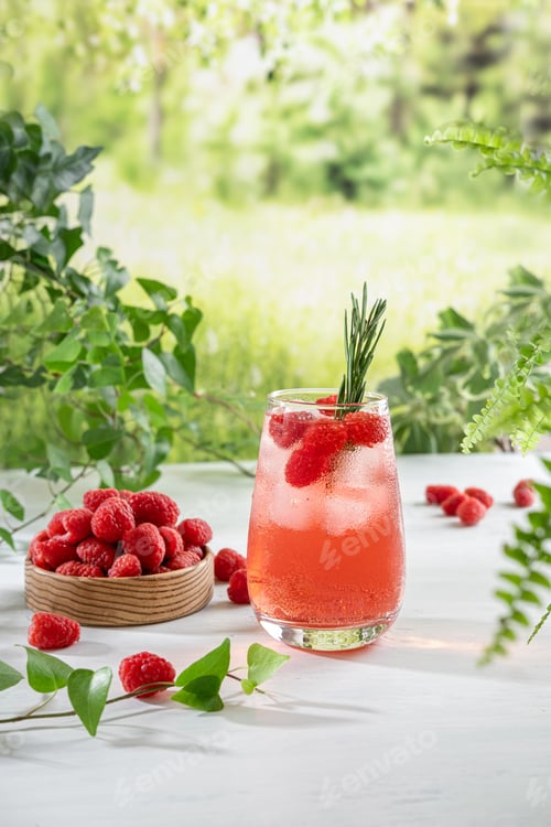 Preview: Summer refreshing non-alcoholic cocktails. Raspberry lemonade garnished with fresh rosemary.