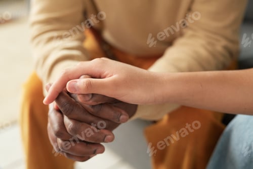 Preview: Holding Hands with Comforting Gesture in Warm Light