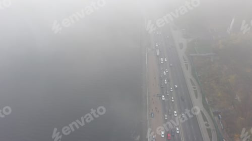 Preview: A city covered in fog. City traffic, aerial view