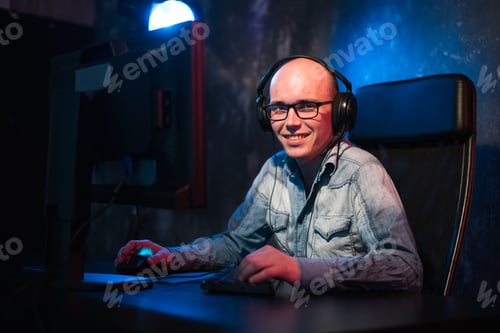 Preview: He like play and win video games. In blue light of display emotional man play computer games online.