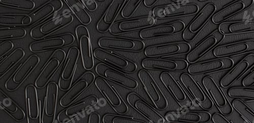 Preview: Paper clips on black background. Top view. Flat lay.