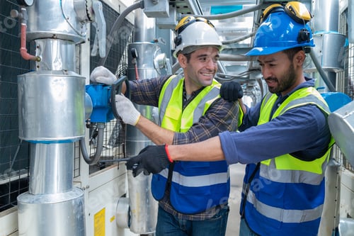 Preview: Engineers Collaborating and Smiling in Industrial Setting
