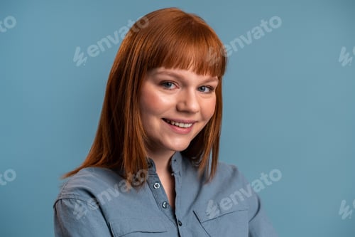 Preview: Close up portrait of pleasant smiling model with ginger beautiful straight unbinding hair isolated