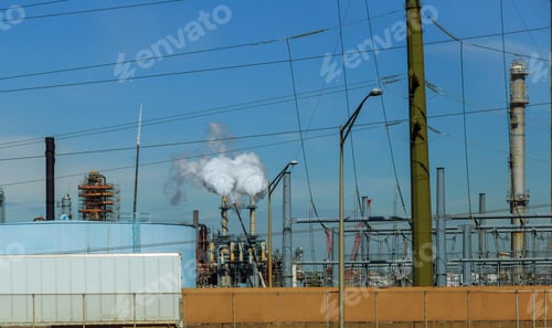 Preview: engineers standing on surrounded by pipelines and pumps inside oil and gas industry