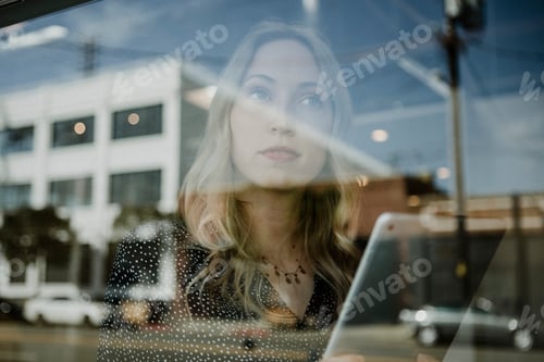 Preview: Pensive Young Woman With Tablet in Urban Setting