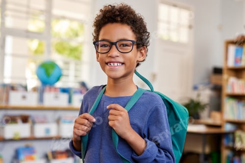 Preview: Smiling mixed race boy with eyeglasses at school