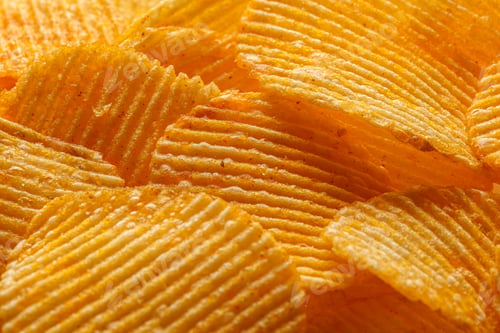 Preview: macro of beautiful corrugated yellow chips under the sun's rays