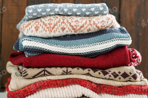 Preview: Warm cotton and woolen sweaters on top of each other prepared for cold season