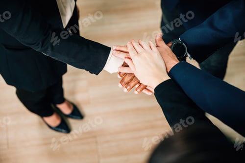 Preview: Diverse colleagues hold hands in a circle in a modern office, celebrating care, equality, and