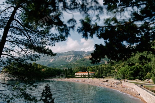 Preview: View through green branches to the beach near Villa Milocer. Montenegro