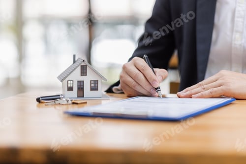 Preview: house model with businessman signs a purchase contract or mortgage for a buy and sell home insurance