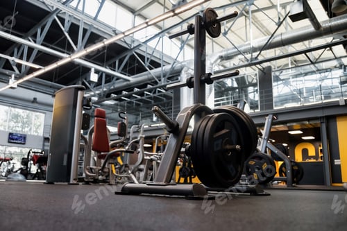 Preview: New fitness center interior with sports equipment sport weight rod on rack