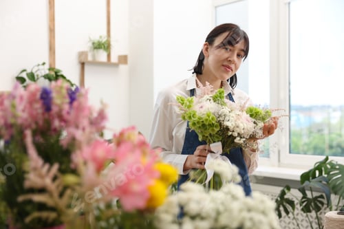 Preview: Florist with beautiful bouquet of flowers indoors