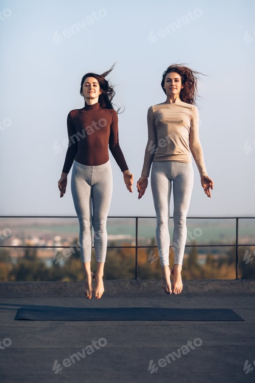Preview: Two beautiful young women synchronously jump on the roof outdoors
