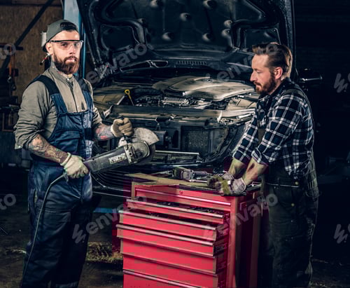 Preview: Two bearded mechanics with an angle grinder.