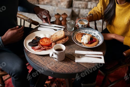 Preview: Close Up Of Couple At Table In Traditional English Pub Eating Breakfast