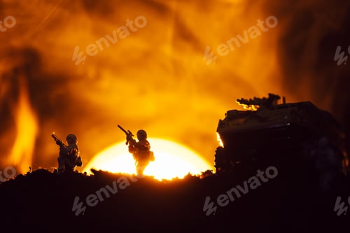 Preview: Silhouettes of toy warriors and tank on battleground with sunset and fire at background