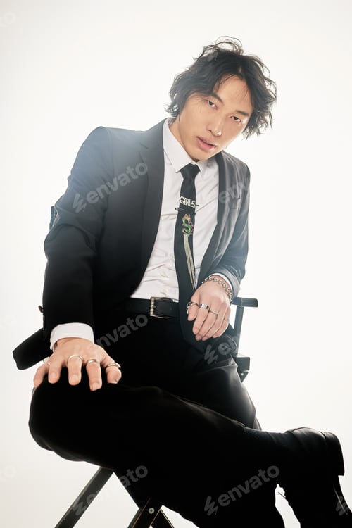Preview: Stylish young asian man posing confidently in a modern urban setting with chic flair