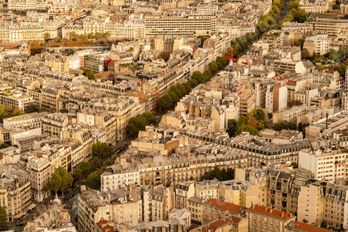 Preview: Aerial view of a dense urban landscape of Paris, at sunset with warm light bathing