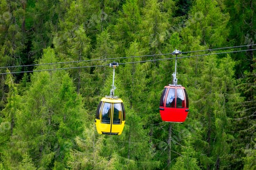 Preview: Mountain chairlift on the background of green pine forest