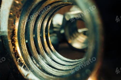 Preview: Macro shot of metal nuts on textured surface
