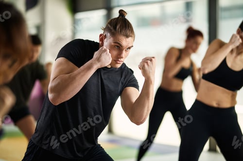 Preview: Young athletic man having martial arts sports training at health club.