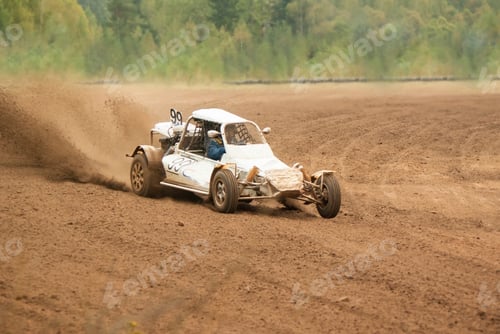 Preview: racing car rides at high speed on a sandy road, under the wheels of flying sand