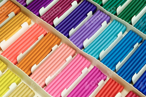 Preview: Pieces of multi-colored plasticine in a cardboard box
