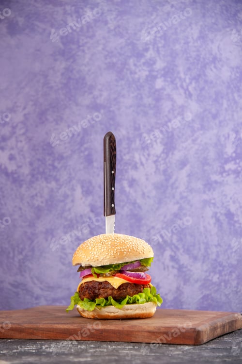 Preview: Knife in delicious meat sandwich on wooden cutting board on isolated ice background with free space