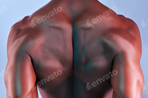 Preview: Shot of a muscular man posing against a studio background