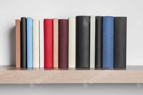 Preview: Many hardcover books on wooden shelf near white wall