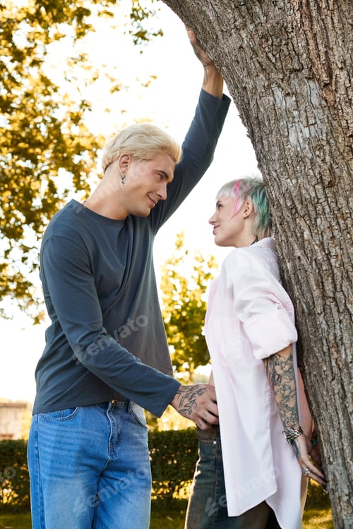 Preview: Loving couple enjoys a serene moment under a tree during a sunny afternoon
