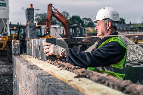 Preview: Workers laying bricks on construction site