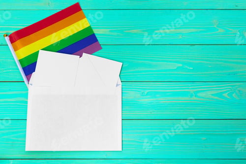 Preview: Bright rainbow gay flag on wooden background and blank space
