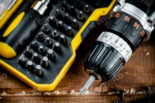 Preview: Working tools. Screwdriver bits. On a wooden background.