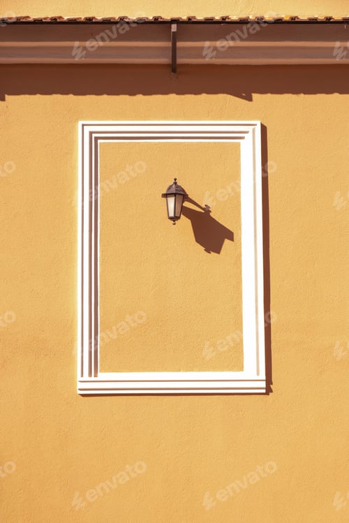 Preview: A street lamp on the orange wall of the house. Minimalist composition