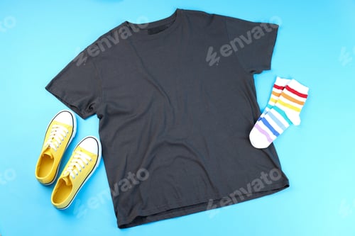 Preview: Blank t-shirt, sneakers and socks on blue background