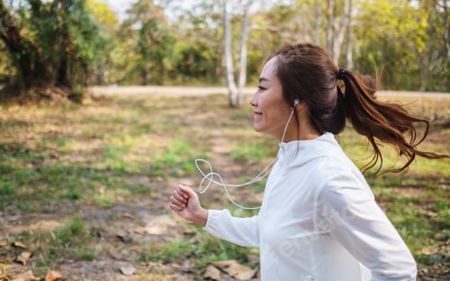 Preview: A young beautiful asian woman jogging in city park in the morning
