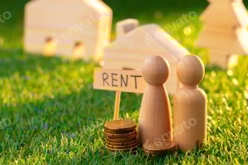 Preview: Wooden toy house with rent sign on grass