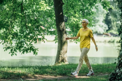 Preview: Mature Woman Enjoying Walking Exercise by the Lake