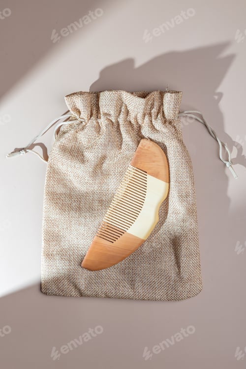 Preview: Top view of canvas bag with wooden haircomb. Natural materials. Personal accessory. Strong hair.